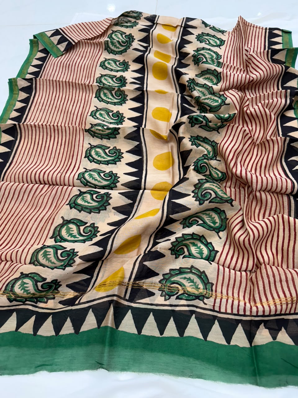 A handcrafted Chanderi silk dupatta featuring a beige and green striped body with intricate green paisley block-print motifs, finished with a solid green border and detailed pallu ends.