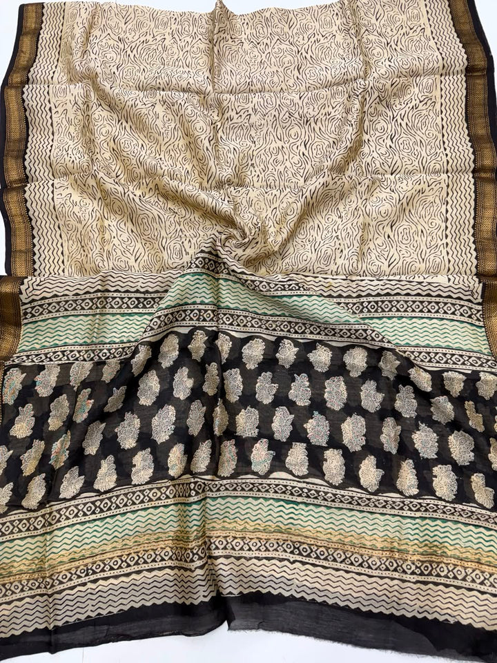 Detailed view of the natural black handloom Maheshwari silk dupatta, highlighting the intricate wavy patterns, block prints, and the elegant handloom woven golden Zari border.