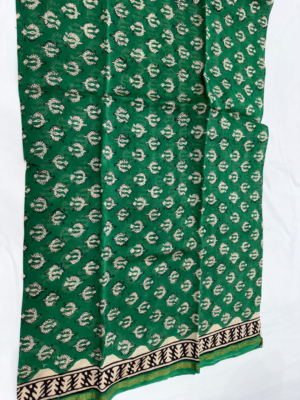A folded length of green Chanderi silk kurta fabric featuring an all-over white and green floral block print, displayed against a clean white background.