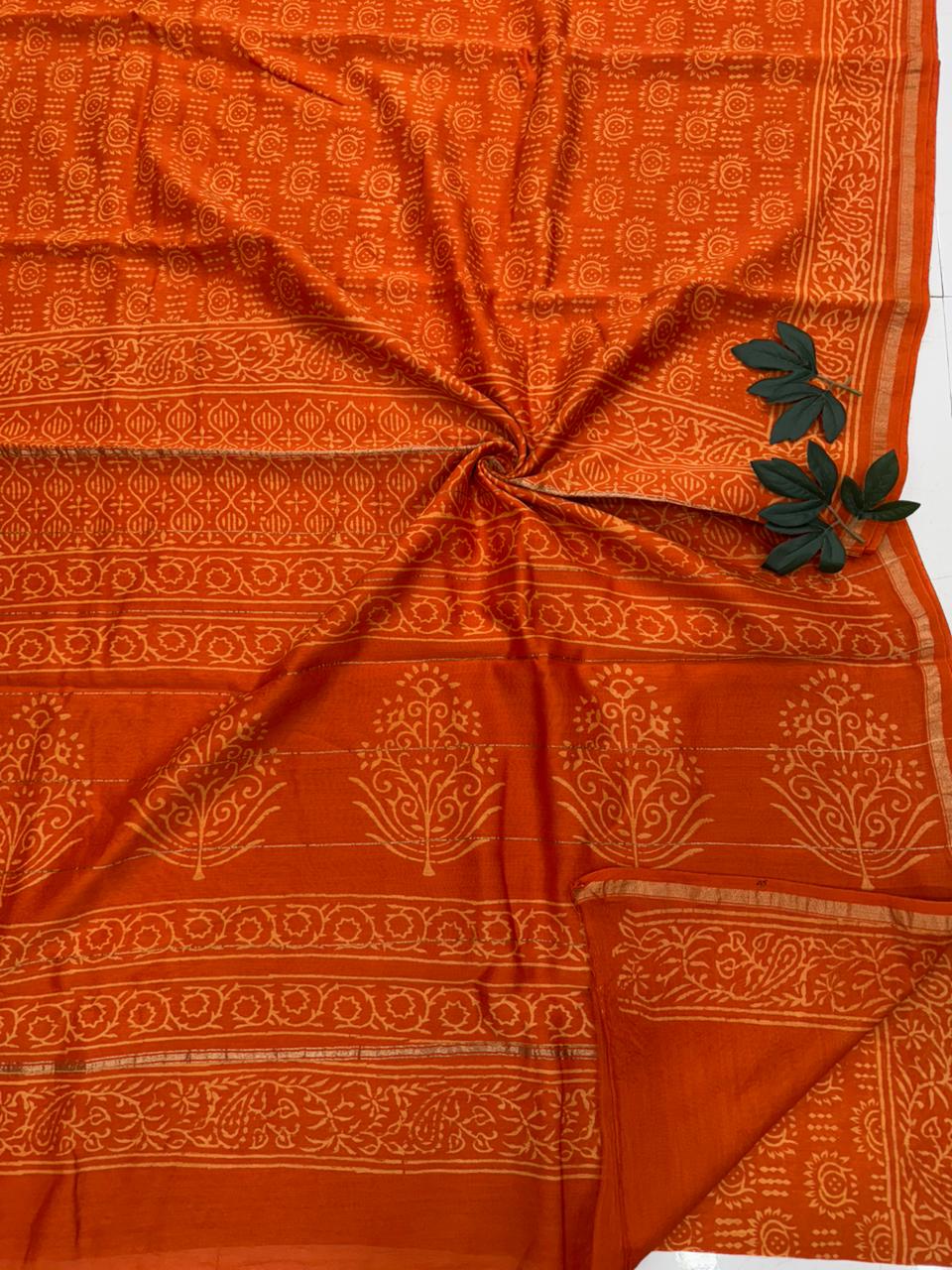 Close-up of Sanganeri handblock motifs on sheer Chanderi silk fabric, showcasing the fine detail of the wooden block artistry.