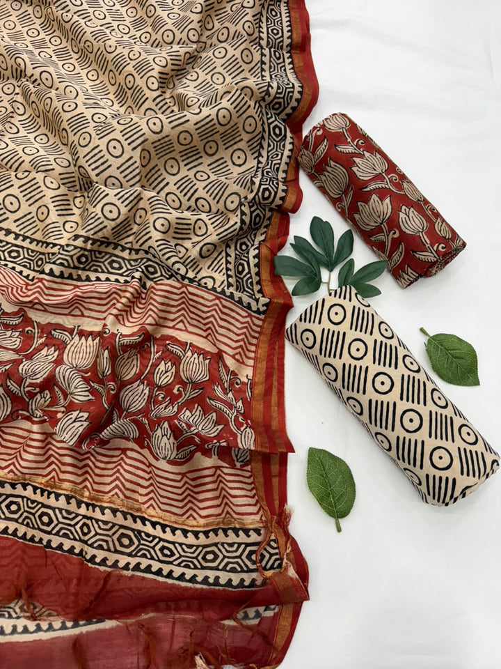 Handcrafted Kalamkari hand-block printed Chanderi silk suit set featuring a beige patterned top, matching dupatta, and solid fabric rolls displayed against a clean background.