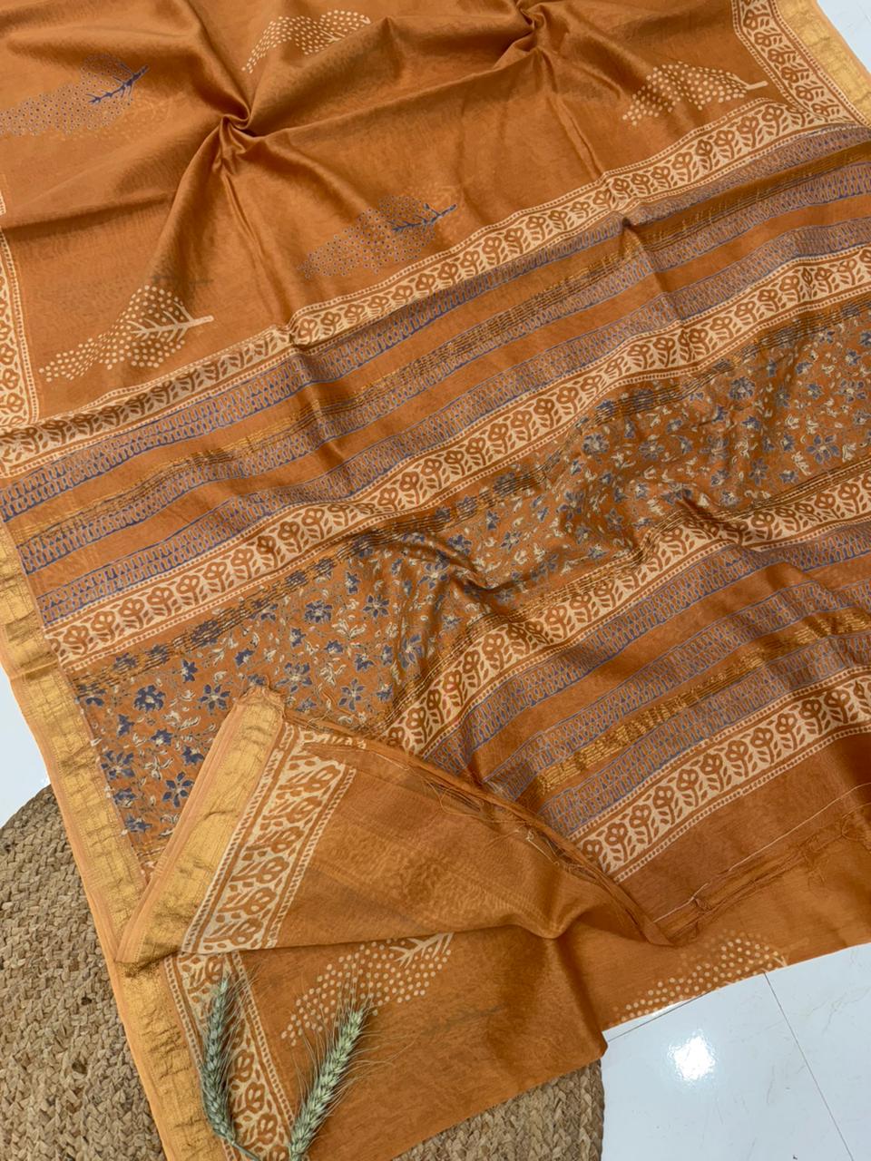 Mustard yellow and ochre Maheshwari silk saree featuring traditional Bagru hand block printed patterns and a classic gold zari border.