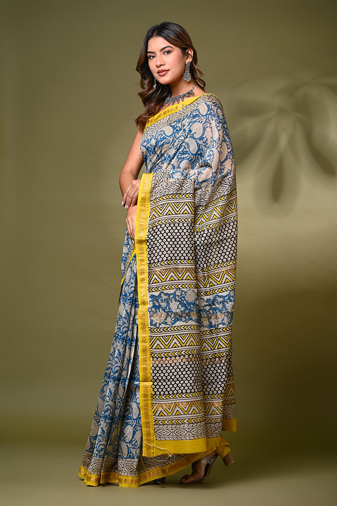 "Authentic Maheshwari silk saree featuring natural indigo Bagru hand-block printing in geometric motifs with a contrasting yellow and gold border."