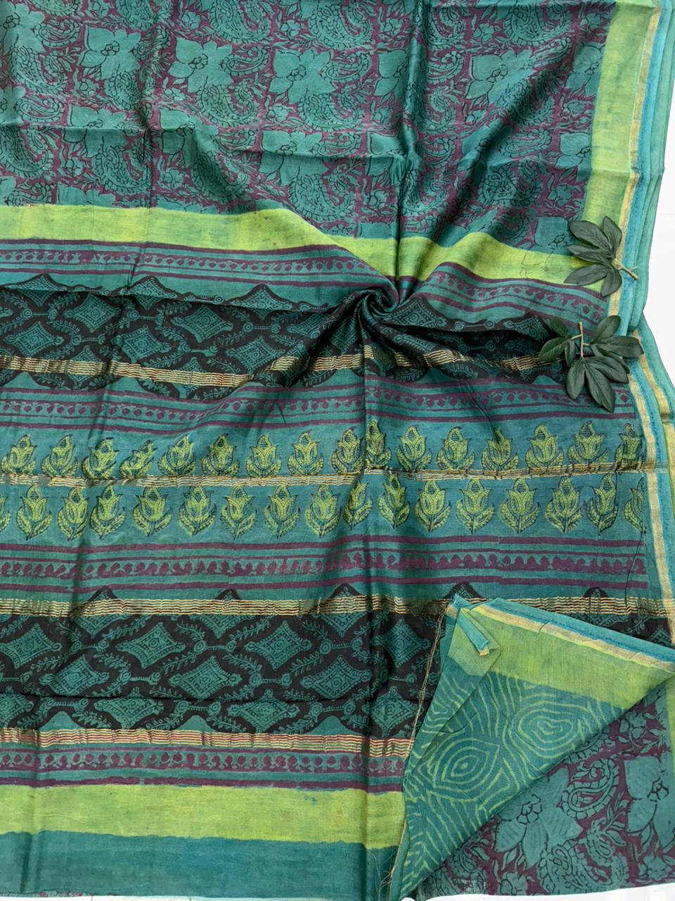 A premium Maheshwari silk saree featuring authentic Bagru handblock printed floral motifs and a traditional woven zari border.