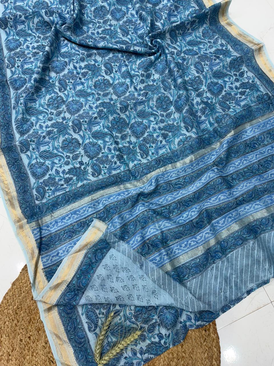 Handblock printed Maheshwari silk saree with traditional floral patterns and a gold zari border, handcrafted by Bagru artisans.