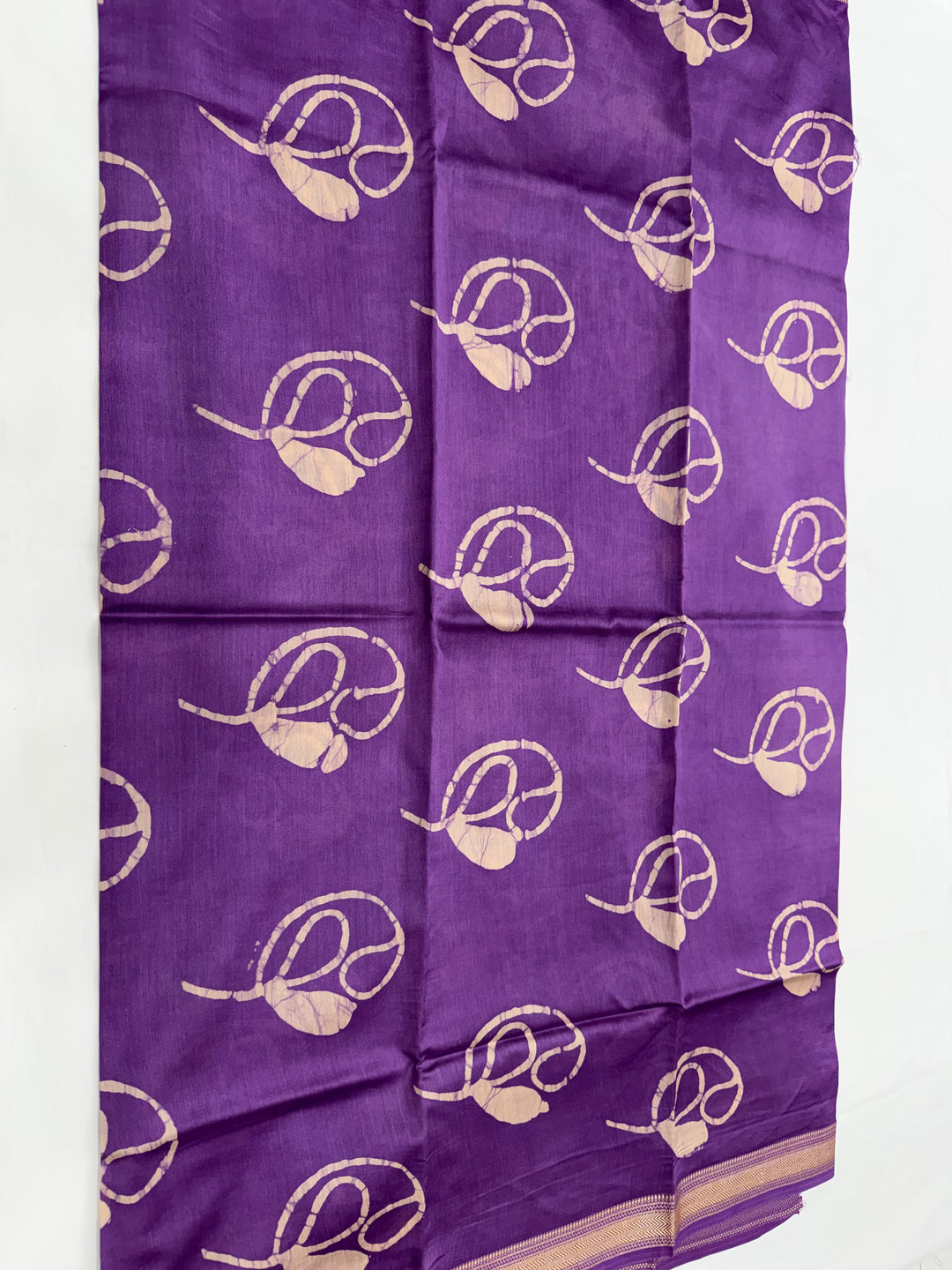 Purple Maheshwari silk unstitched kurta fabric featuring abstract floral block prints and decorative green leaf styling props