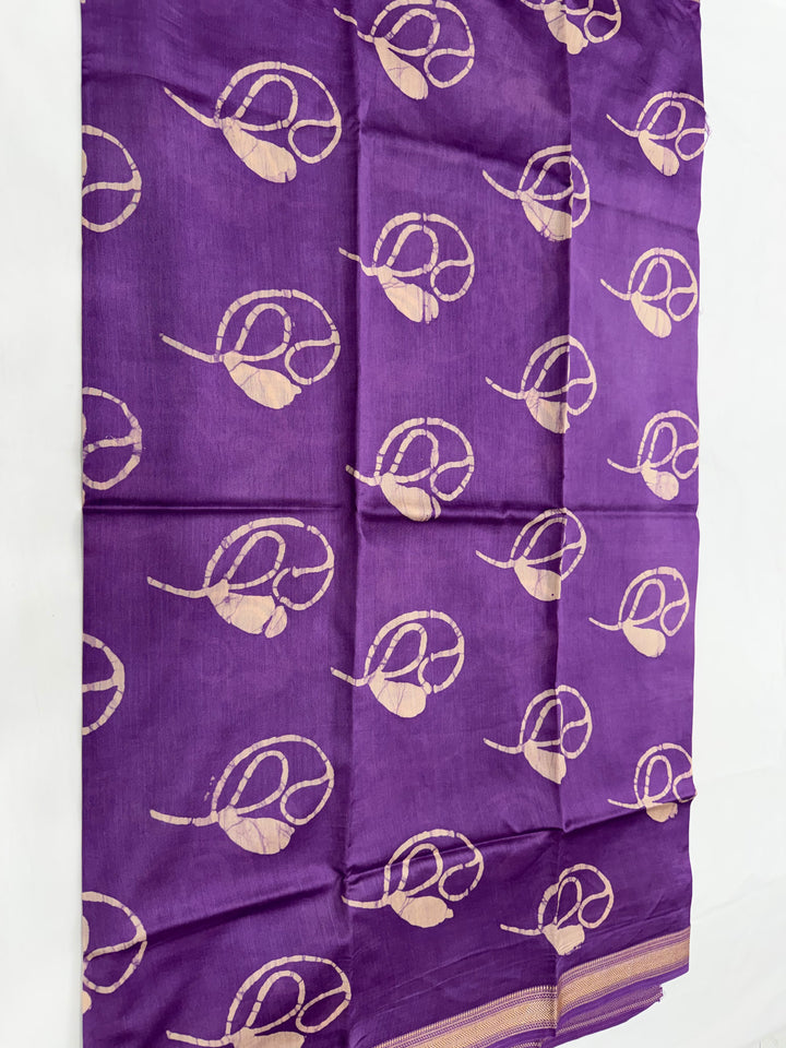 Purple Maheshwari silk unstitched kurta fabric featuring abstract floral block prints and decorative green leaf styling props