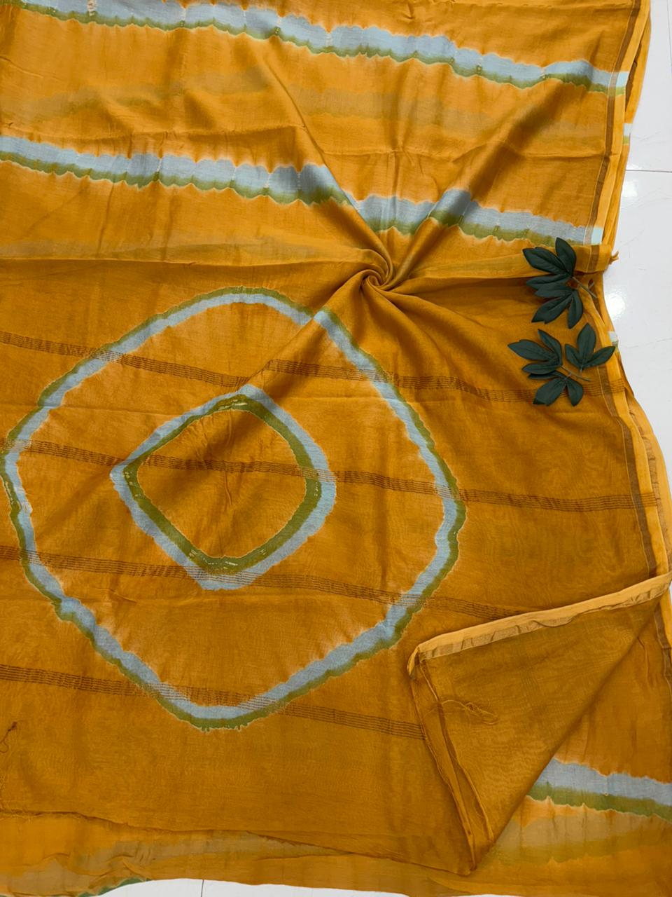 A lightweight Chanderi silk saree featuring a hand-dyed Shibori pattern and a traditional gold zari border.