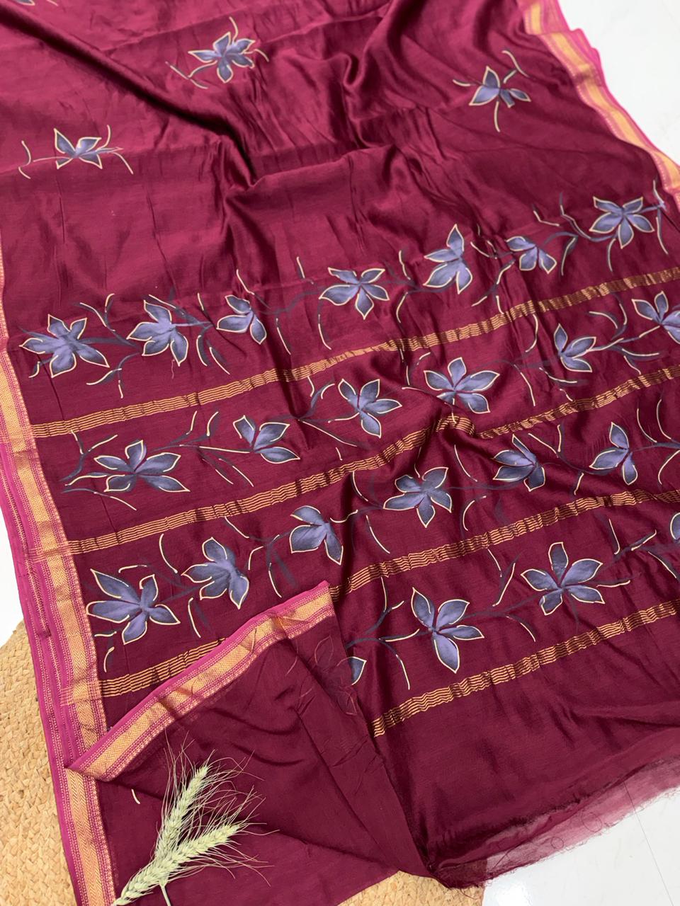 "Artisan-crafted hand painted Maheshwari silk saree with natural floral designs and gold border details."