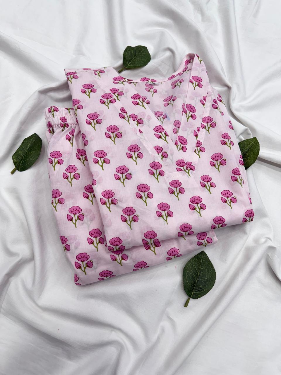 A detailed look at both the baby pink printed kurta and matching bottom fabric patterns placed together.