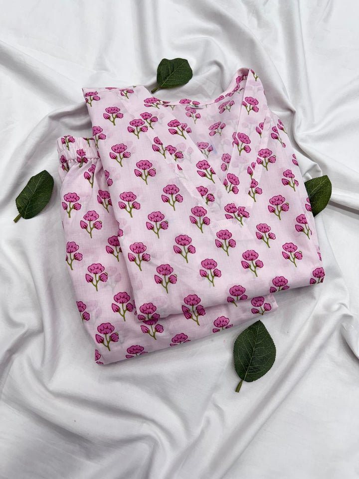A detailed look at both the baby pink printed kurta and matching bottom fabric patterns placed together.