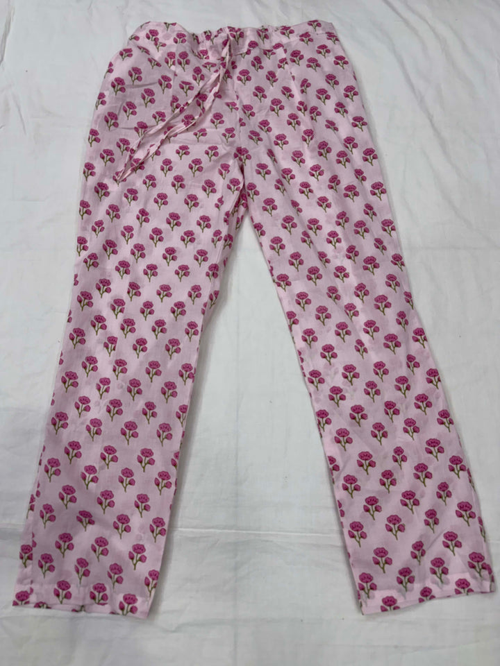 Detailed view of the matching baby pink printed cotton straight pants, highlighting the fabric texture and print pattern.