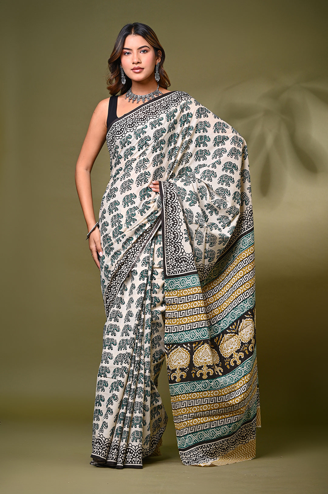 ull-length front view of a model in an authentic Bagru handblock print soft mulmul cotton saree, featuring repeating black elephant motifs on a cream base with an intricate traditional border.