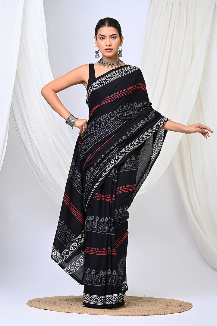 A woman modeling a traditional Bagru hand block print soft mulmul cotton saree in classic black, white, and red motifs.