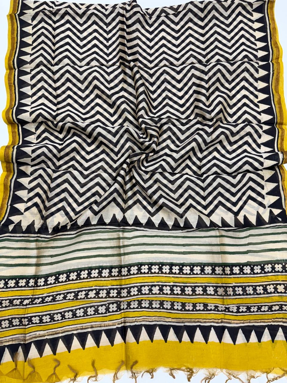 Bagru hand block printed pure Chanderi silk dupatta featuring a black and white chevron pattern with yellow floral borders and tassel details.