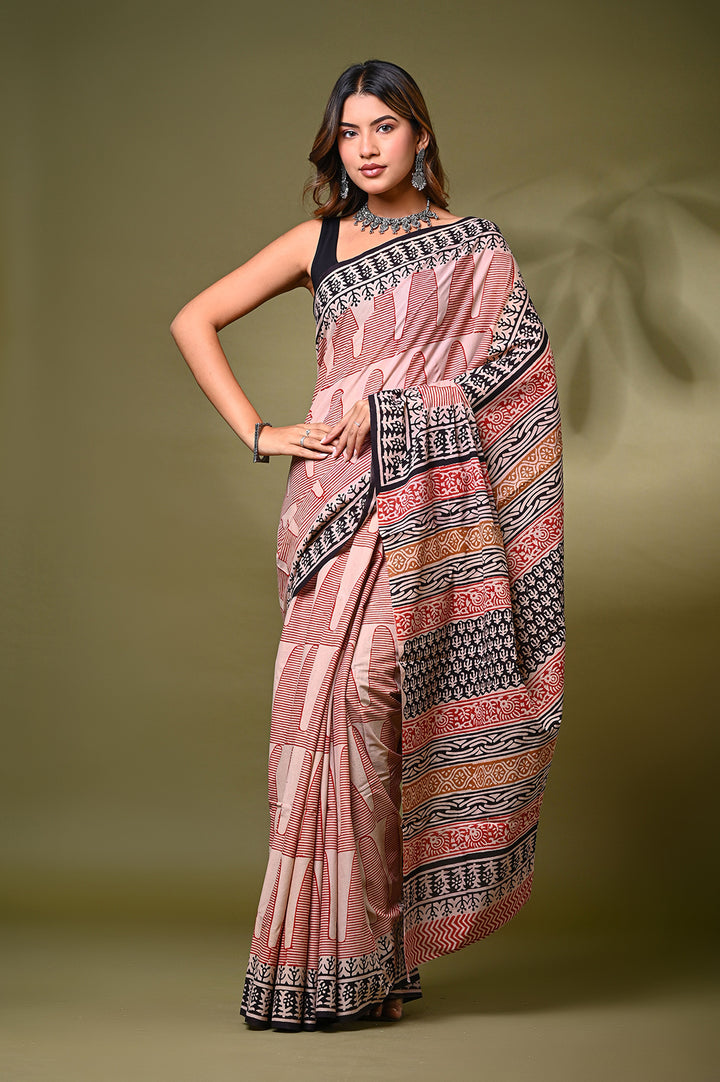 Front view of a model in an authentic cream and off-white Bagru handblock print mulmul cotton saree, featuring intricate maroon geometric patterns and a heavy black block-printed border.