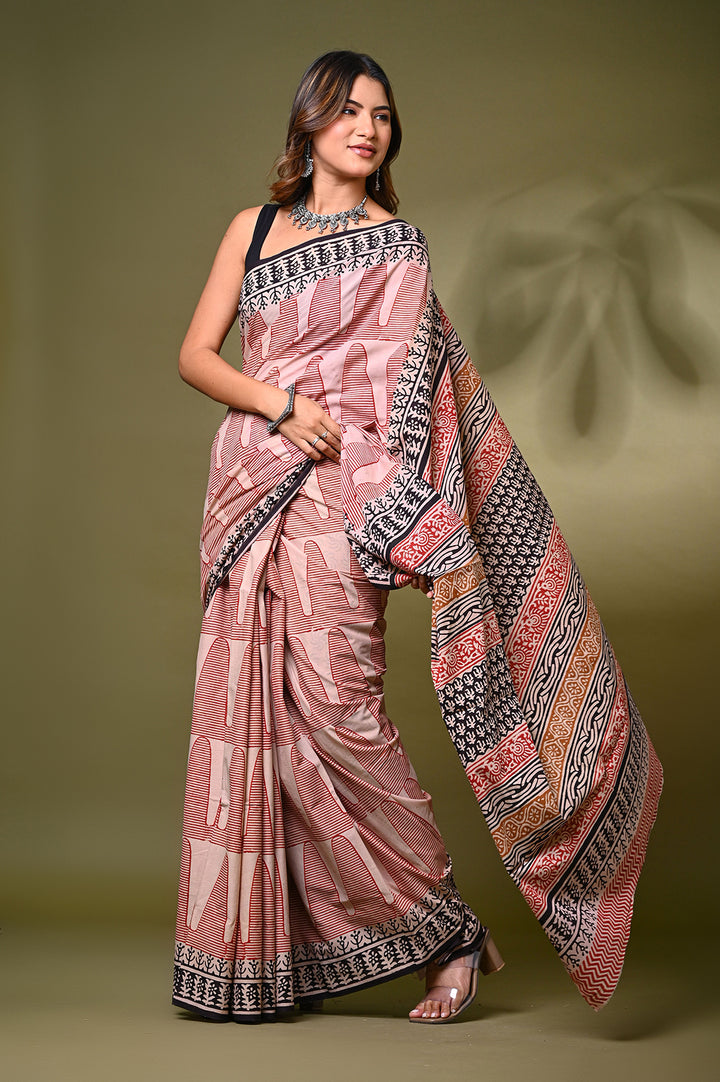 Full-length view of a model showcasing the detailed pallu of a maroon and cream Bagru handblock print mulmul cotton saree, featuring traditional tree motifs and an intricate black geometric border.