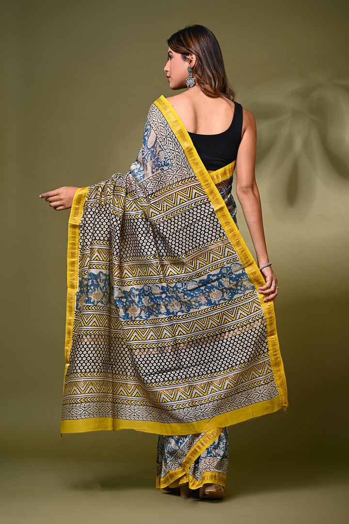 "Blue and cream Bagru print Maheshwari silk saree with yellow border by Bagru Hastkala Printers."