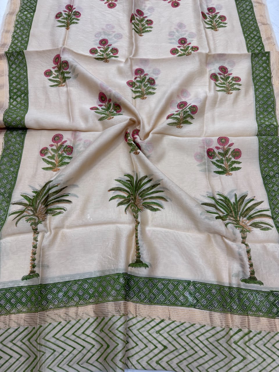 Detailed view of the lightweight beige Maheshwari silk dupatta, highlighting the distinct hand block printed green palm tree motifs, chevron patterns, and a golden Zari border.