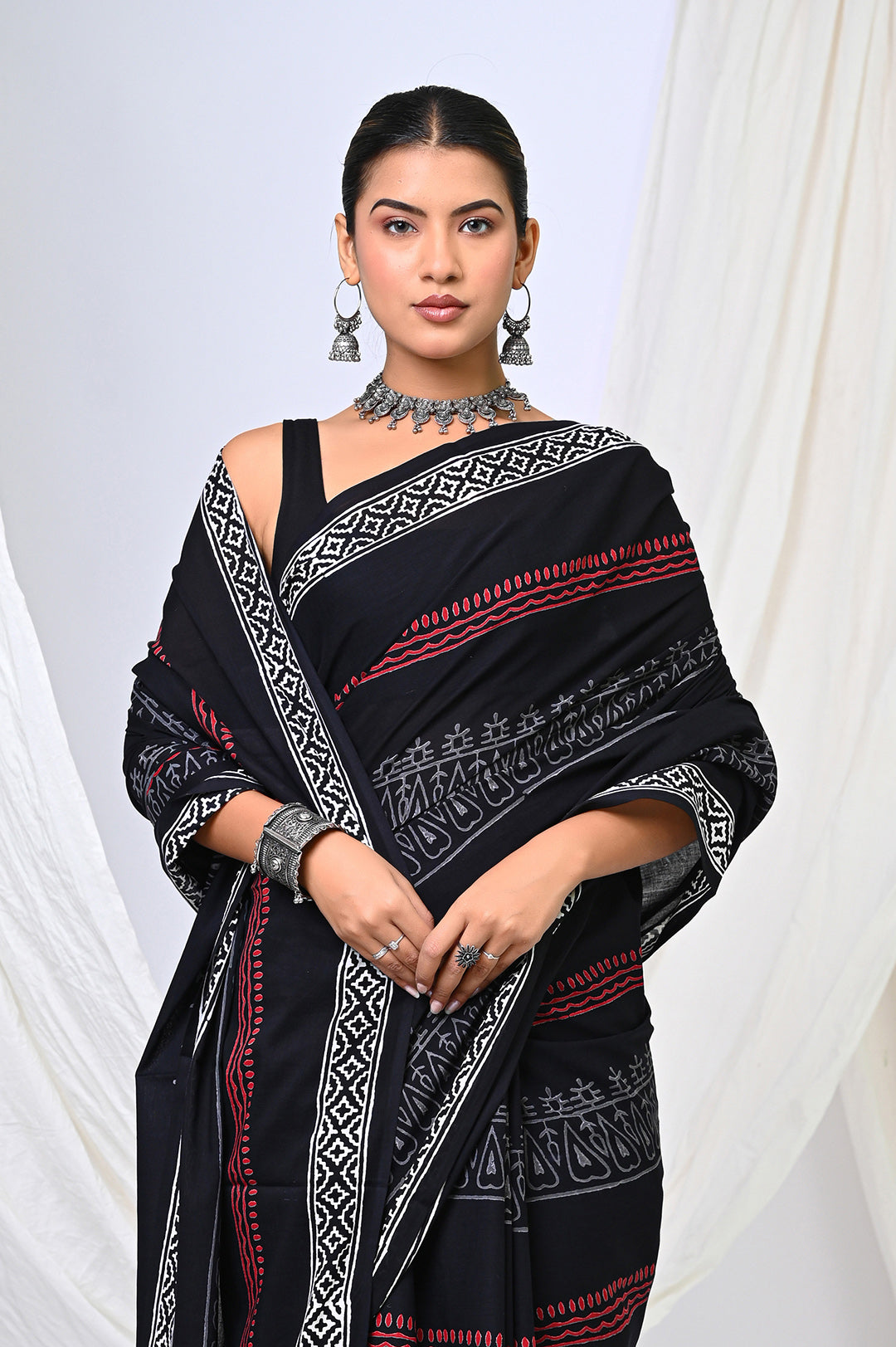 Premium Rajasthani hand block printed black and white mulmul saree with red details, perfect for elegant festive and office wear.