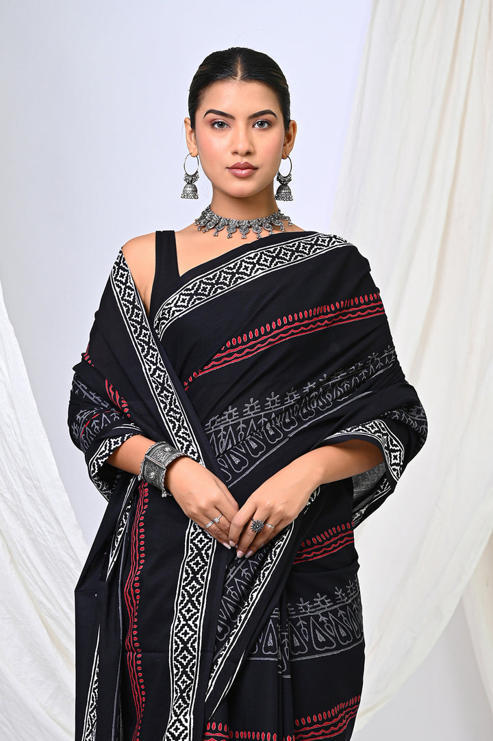Premium Rajasthani hand block printed black and white mulmul saree with red details, perfect for elegant festive and office wear.