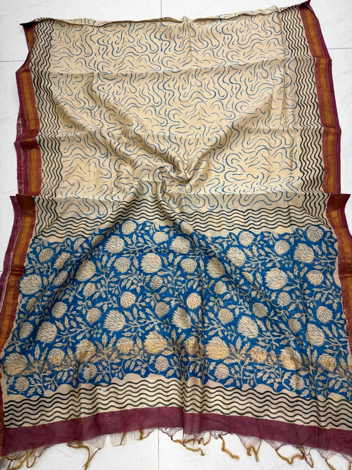 Detailed view of the beige and blue handloom Maheshwari silk dupatta, highlighting the traditional wavy block prints, geometric accents, and a contrasting rich maroon handloom woven golden Zari border.