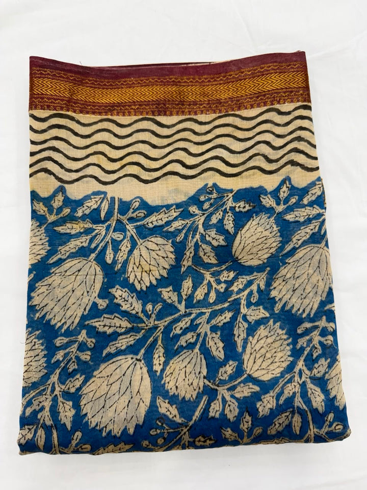 Close-up of the unstitched deep blue Maheshwari silk kurta fabric, showcasing the detailed all-over floral and vine Bagru hand block print patterns in beige and cream tones.