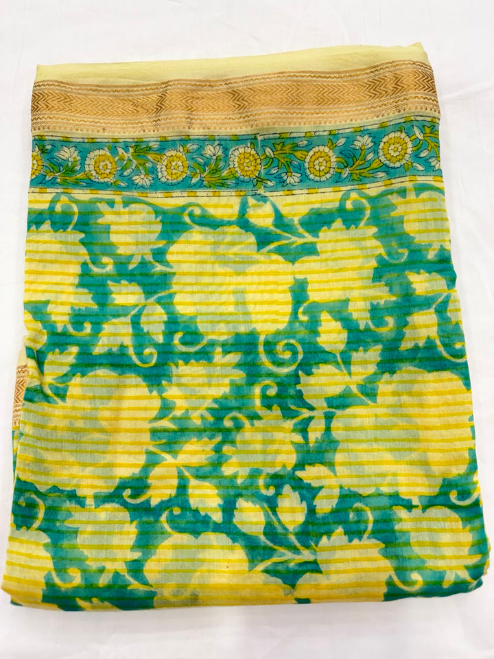 Close-up of the unstitched bright yellow Maheshwari silk kurta fabric, featuring a clean, minimalist pattern of hand block printed small green and blue dots.
