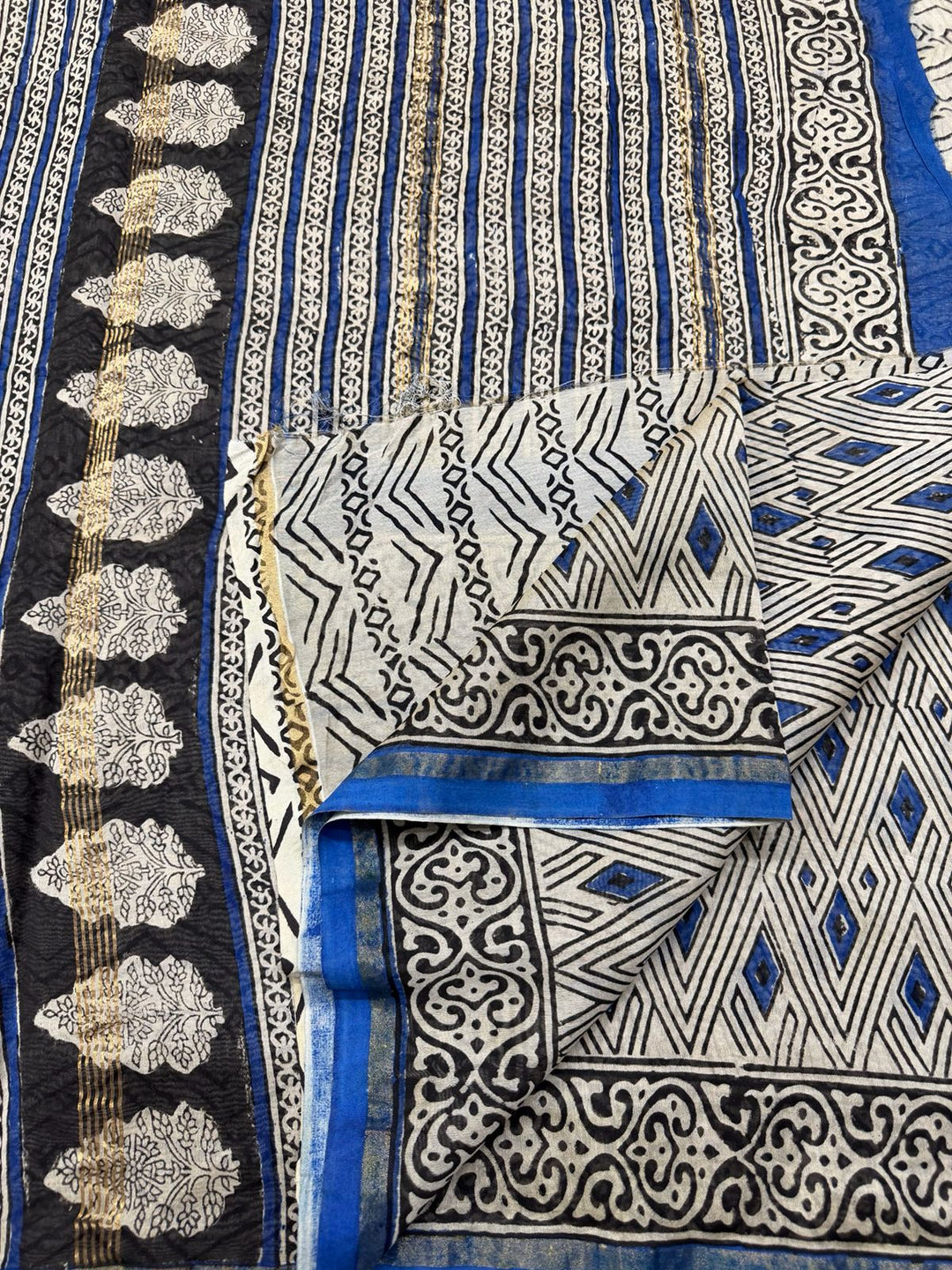 Blue and white Chanderi Silk saree with traditional Bagru hand block prints and a gold border.