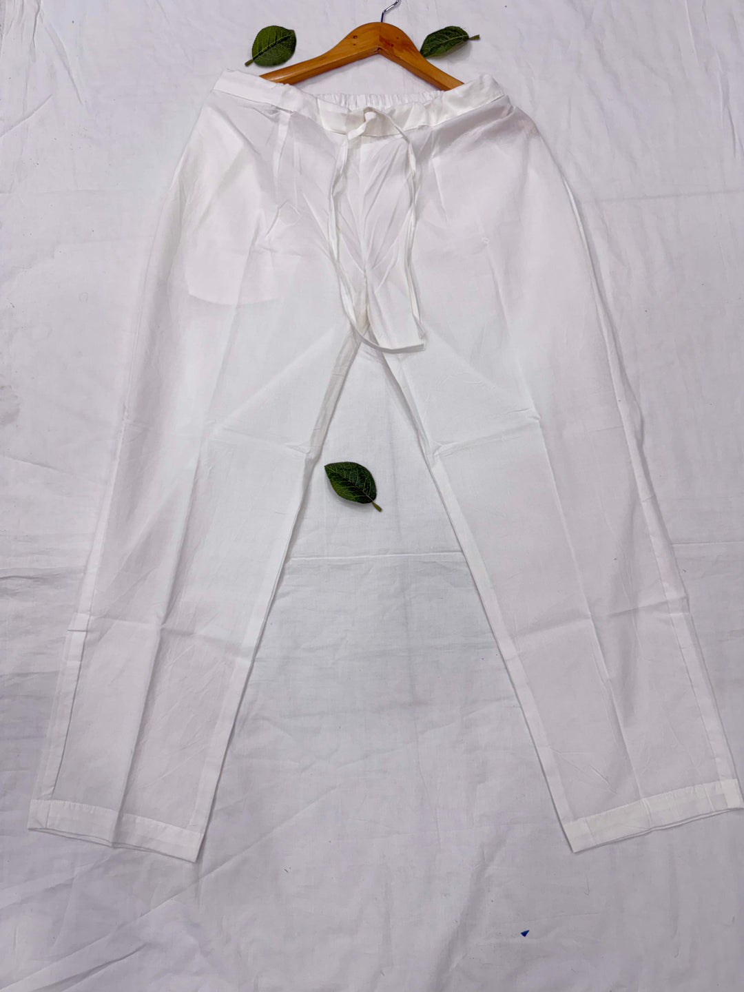 Tailored classic white cotton pants featuring a comfortable regular fit, designed for styling with ethnic tops and tunics.