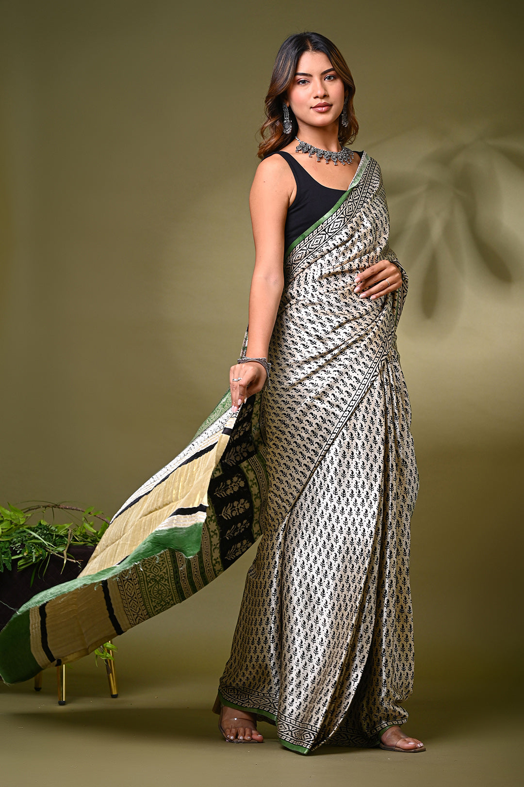An authentic eco-friendly plant-based dyed cream Modal Silk saree with an all-over small floral dot pattern and a traditional patterned border.