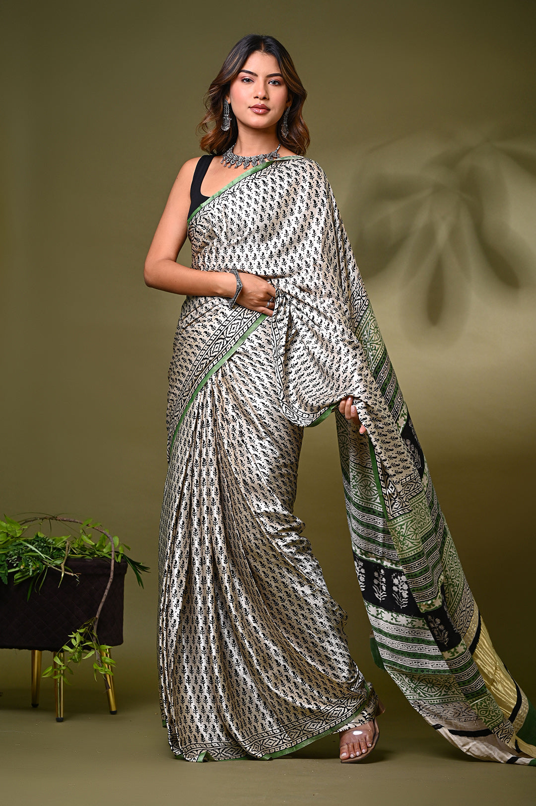 Premium natural cream Modal Silk saree handcrafted with 100% eco-friendly plant-based dyes, showcasing traditional Rajasthani block prints and a glossy texture.