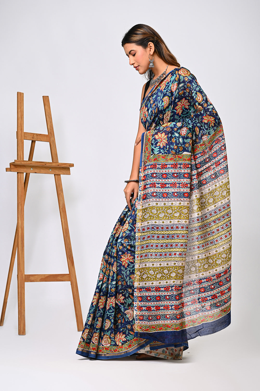 An authentic hand-stamped blue Chanderi silk saree showcasing a sheer, lustrous texture, traditional fine block work, and a matching patterned border.