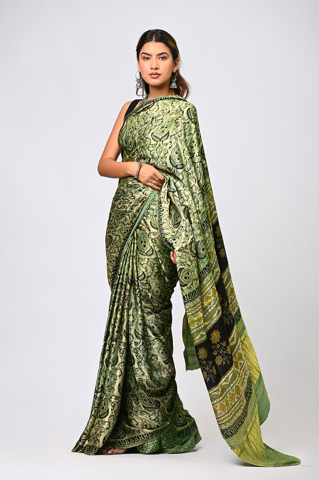 Hand-stamped geometric Lagdi Patta design on a premium natural green modal silk saree from Rajasthan.