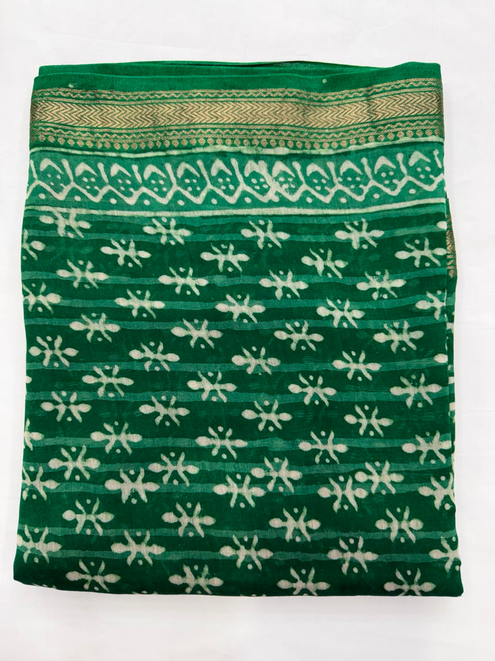 Close-up of the unstitched green Maheshwari silk kurta fabric, highlighting the traditional mud-resist Dabu hand block printed white geometric and floral patterns.
