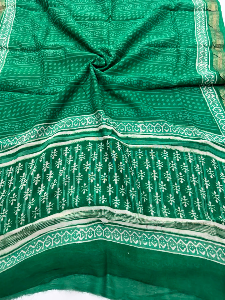 Detailed view of the pure green Maheshwari silk dupatta, highlighting the intricate Dabu block prints, unique resist textures, and the elegant handloom woven golden Zari border.