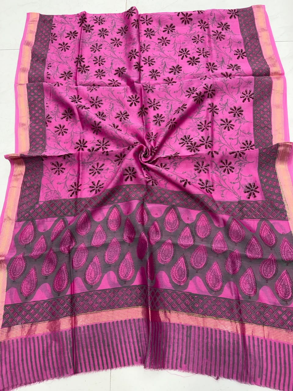 Detailed view of the premium pink handloom Maheshwari silk dupatta, highlighting the intricate black floral block prints, traditional patterns, and a rich handloom woven golden Zari border.