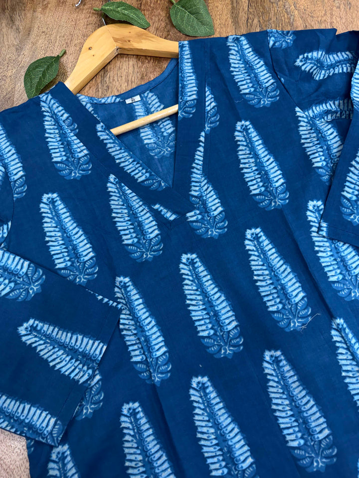Detailed view of the V-neck design and intricate white ethnic prints on a rich indigo blue women's kurta.