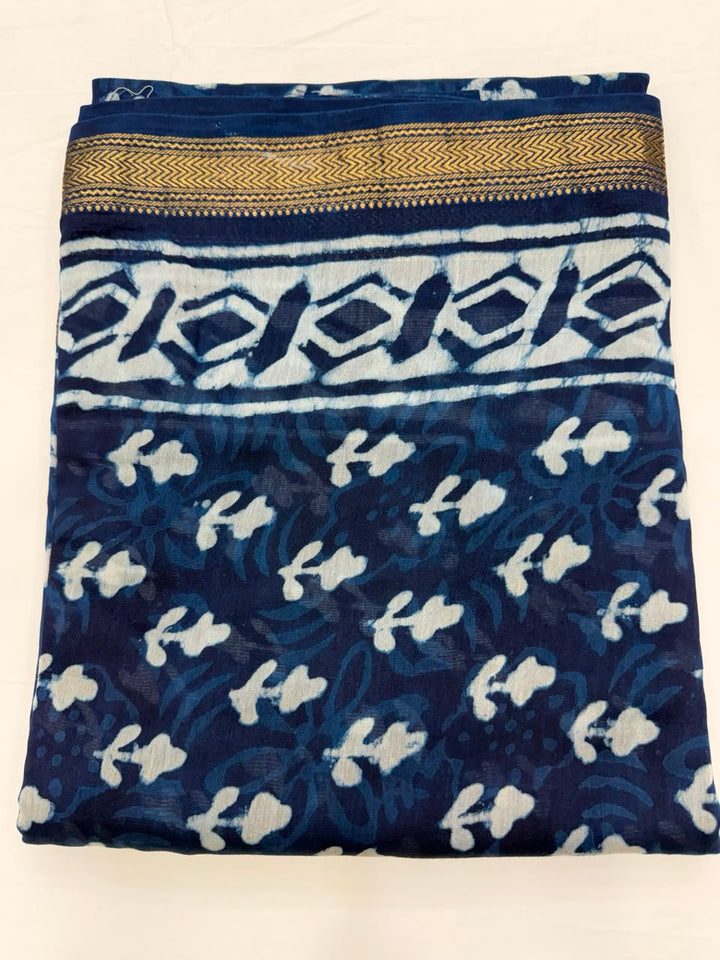 Close-up of the unstitched indigo blue Maheshwari silk kurta fabric, featuring traditional mud-resist Dabu hand block printed small scattered floral buti motifs.