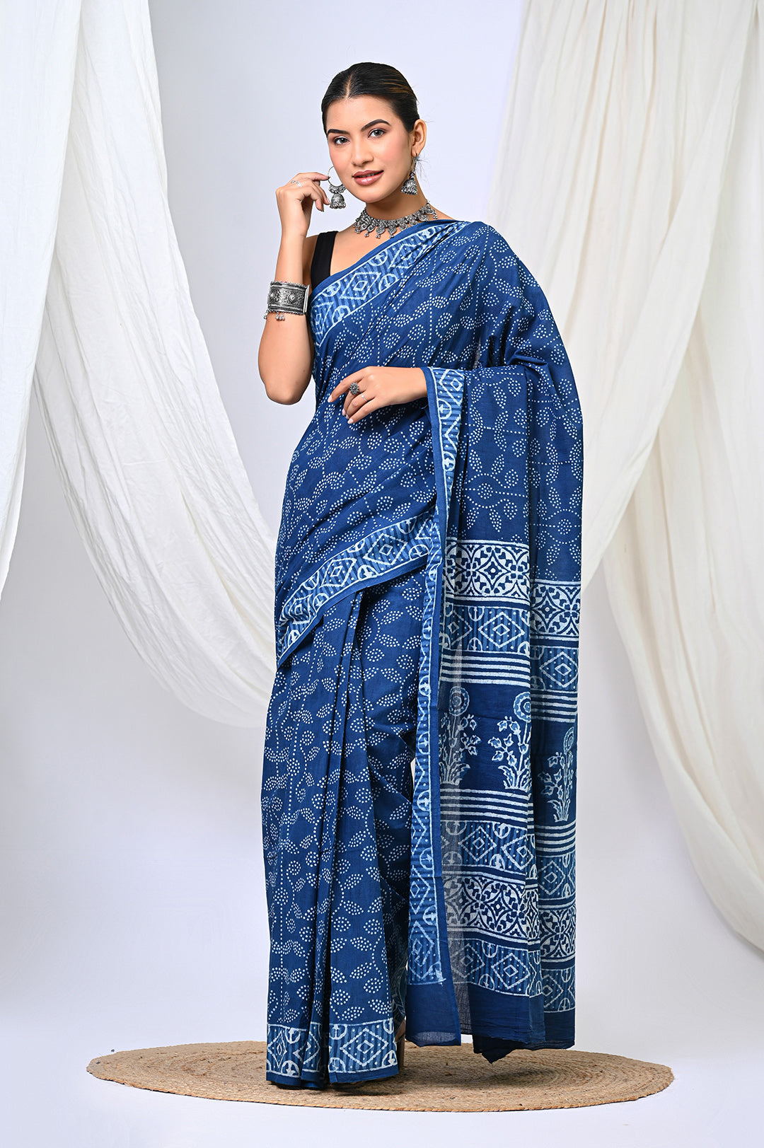 Front view of a pure natural indigo blue Dabu handblock print mulmul cotton saree featuring an all-over geometric dot print design and a traditional designer block-printed pallu.