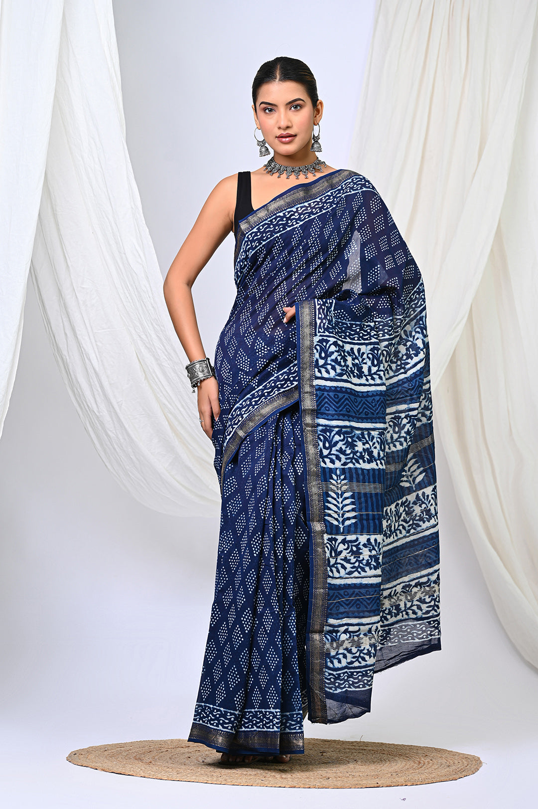 Close-up of Indigo Dabu Print Saree showing intricate mud-resist block prints and a classic golden Maheshwari silk border