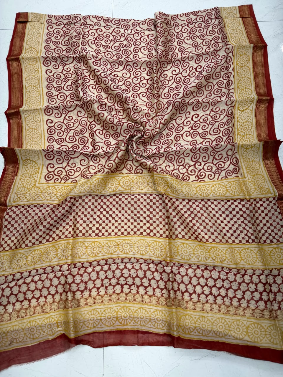 Detailed view of the cream and maroon handloom Maheshwari silk dupatta, showcasing fine geometric blocks, traditional patterns, and a premium handloom woven golden Zari border.