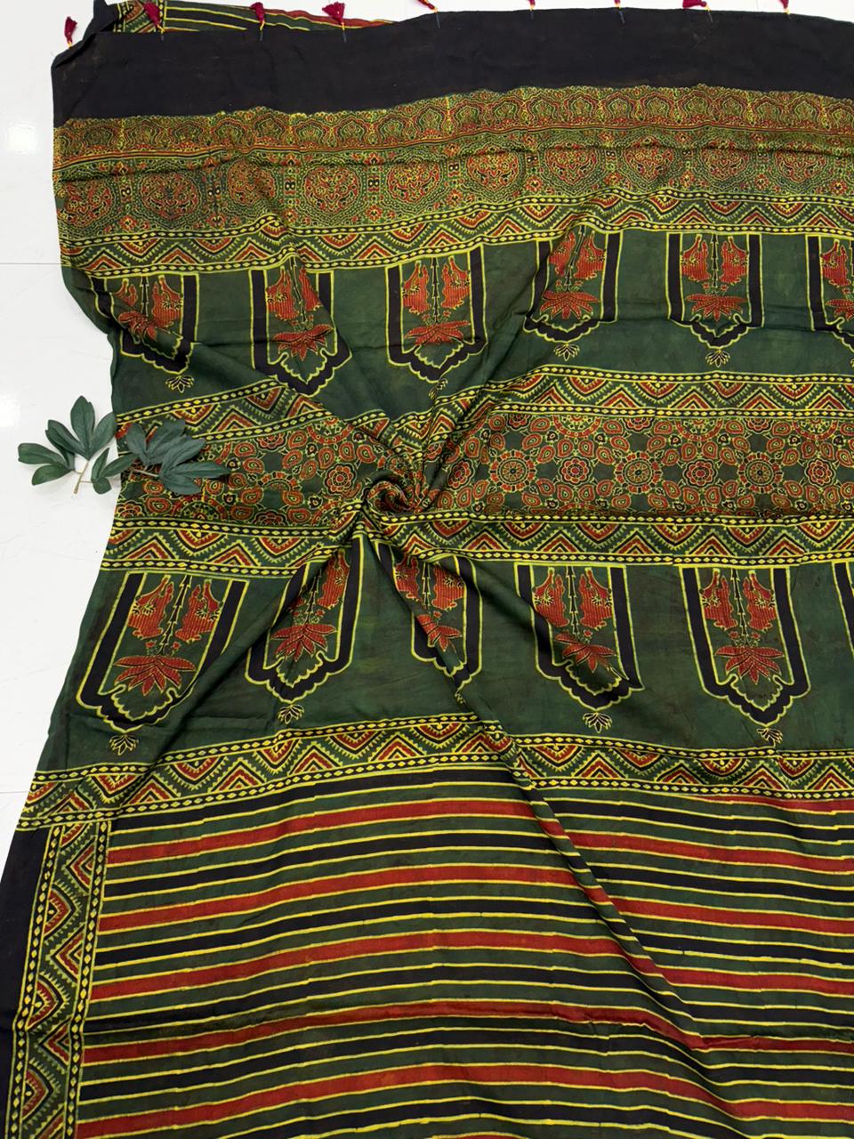 Green and red patterned fabric with a black border modal silk saree with blouse pes ajrakh print .