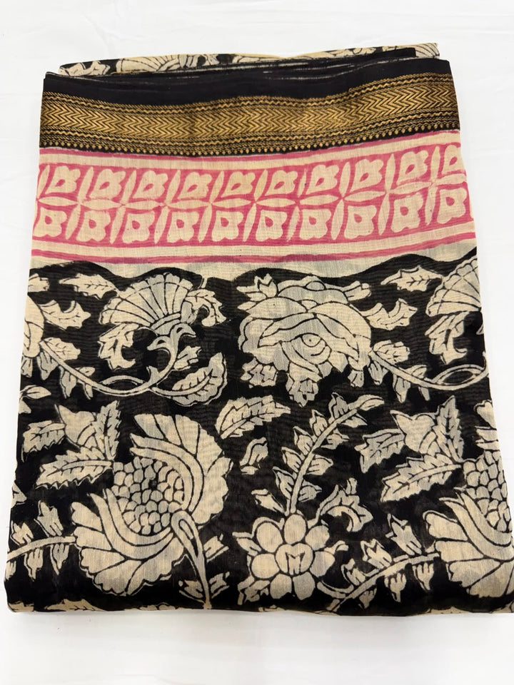 Close-up of the unstitched natural black Maheshwari silk kurta fabric, featuring traditional Bagru hand block printed floral buti motifs in a golden-beige hue using 100% vegetable dyes.