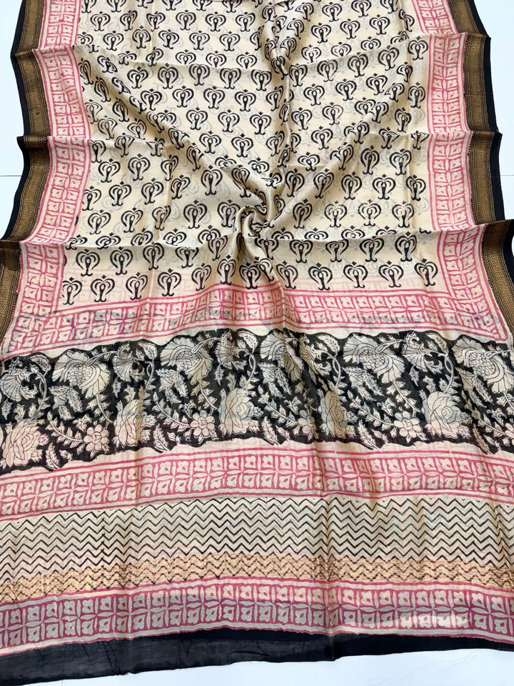 Detailed view of the natural black handloom Maheshwari silk dupatta, highlighting the intricate wavy patterns, block prints, and the elegant handloom woven golden Zari border.