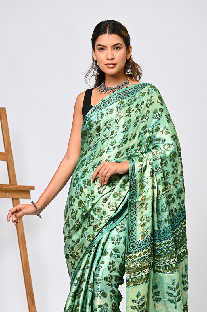 Full-length view of a premium natural green Modal Silk saree handcrafted with plant-based botanical dyes, showcasing its fluid drape, glossy texture, and traditional hand block printed motifs.