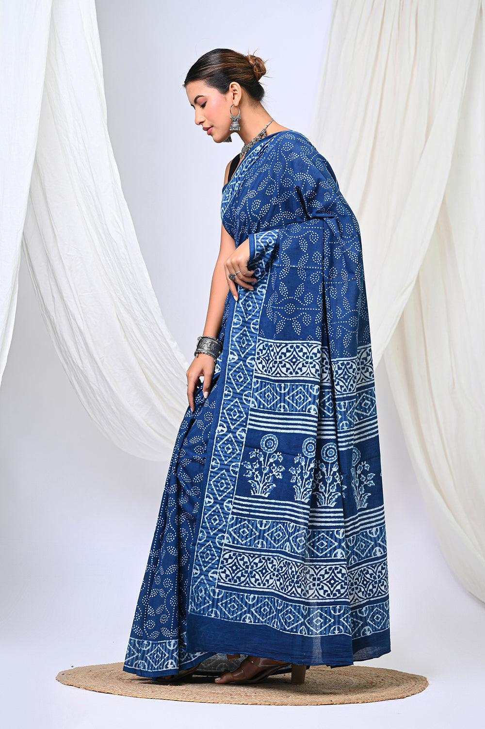 Full-length display of an authentic Rajasthani mud-resist Dabu printed soft mulmul cotton saree in plant-based natural indigo blue with detailed ethnic geometric patterns.
