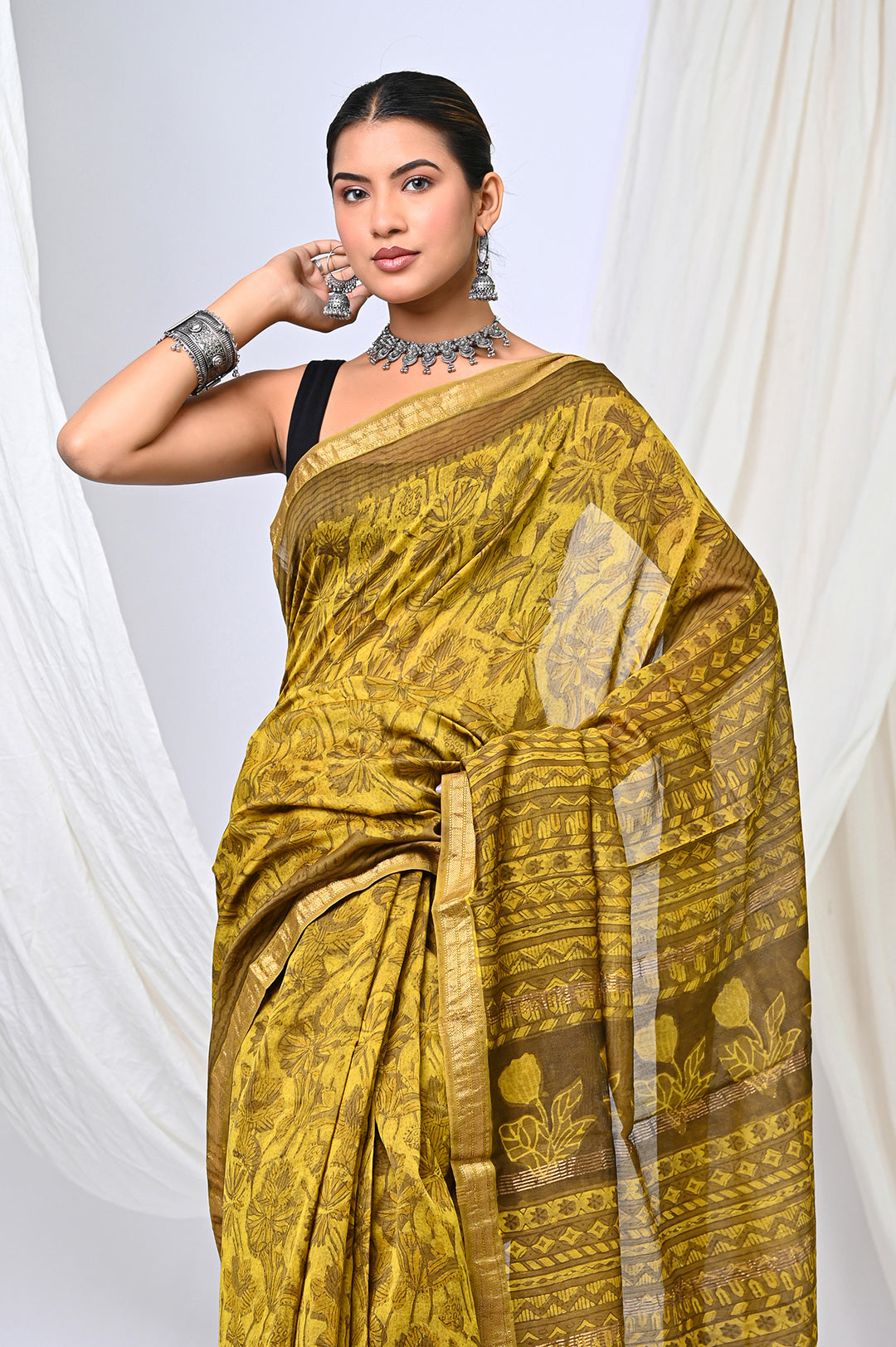 Full-length view of a lustrous golden-mustard Maheshwari silk saree handcrafted with 100% plant-based Vanaspati dyes and a repeating geometric wooden block print.