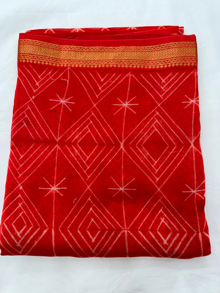 Close-up of the unstitched orange Maheshwari silk kurta fabric, highlighting the crisp white diamond patterns created through traditional hand-stitched and resist-dyed Shibori art.