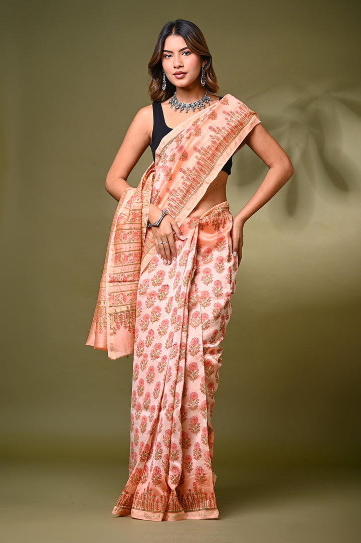 An authentic pastel peach Chanderi silk saree showcasing a sheer, lightweight texture and fine Rajasthani hand block printed buti motifs.